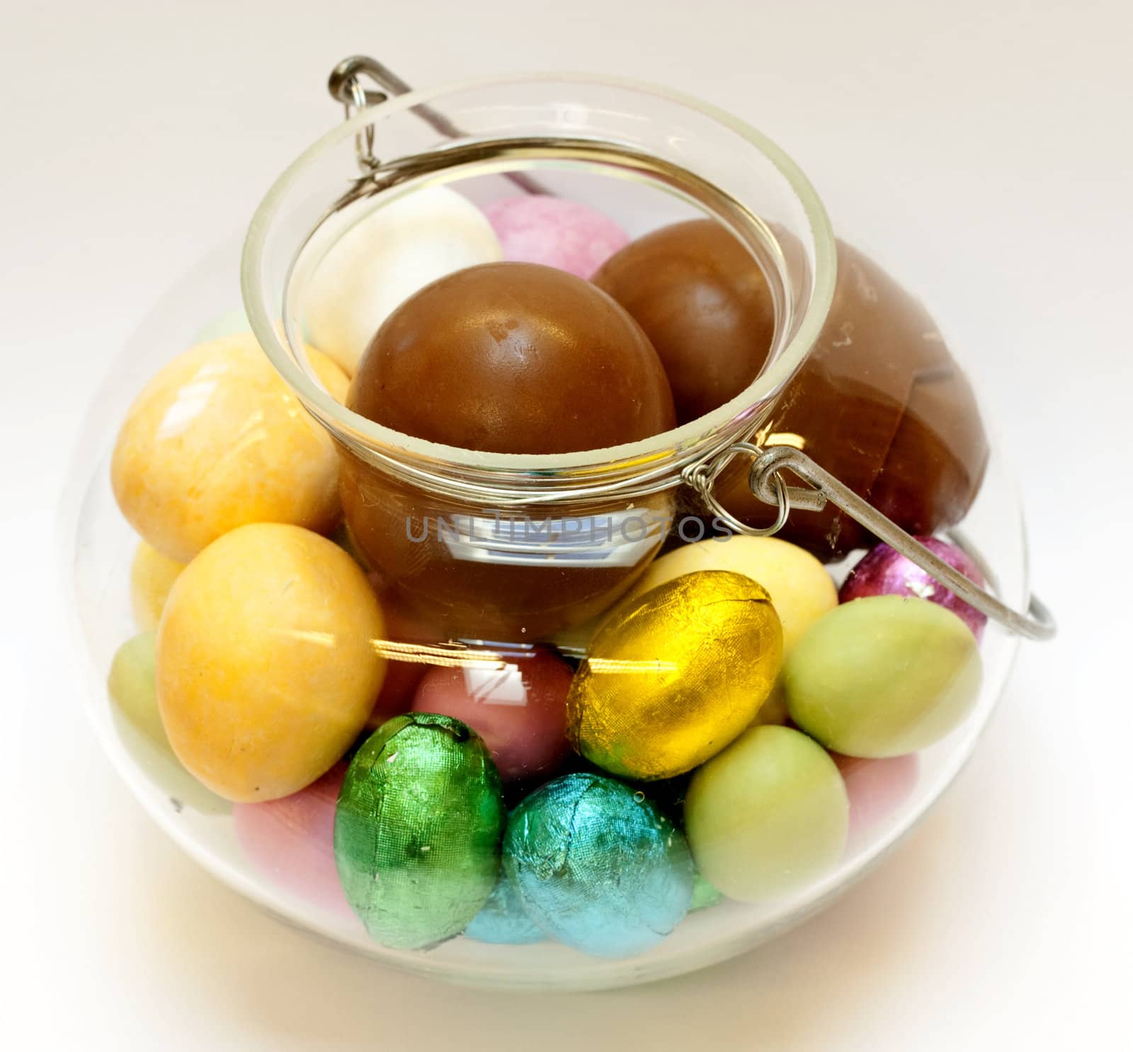 Colorful easter egg chocolates in a glass bowl