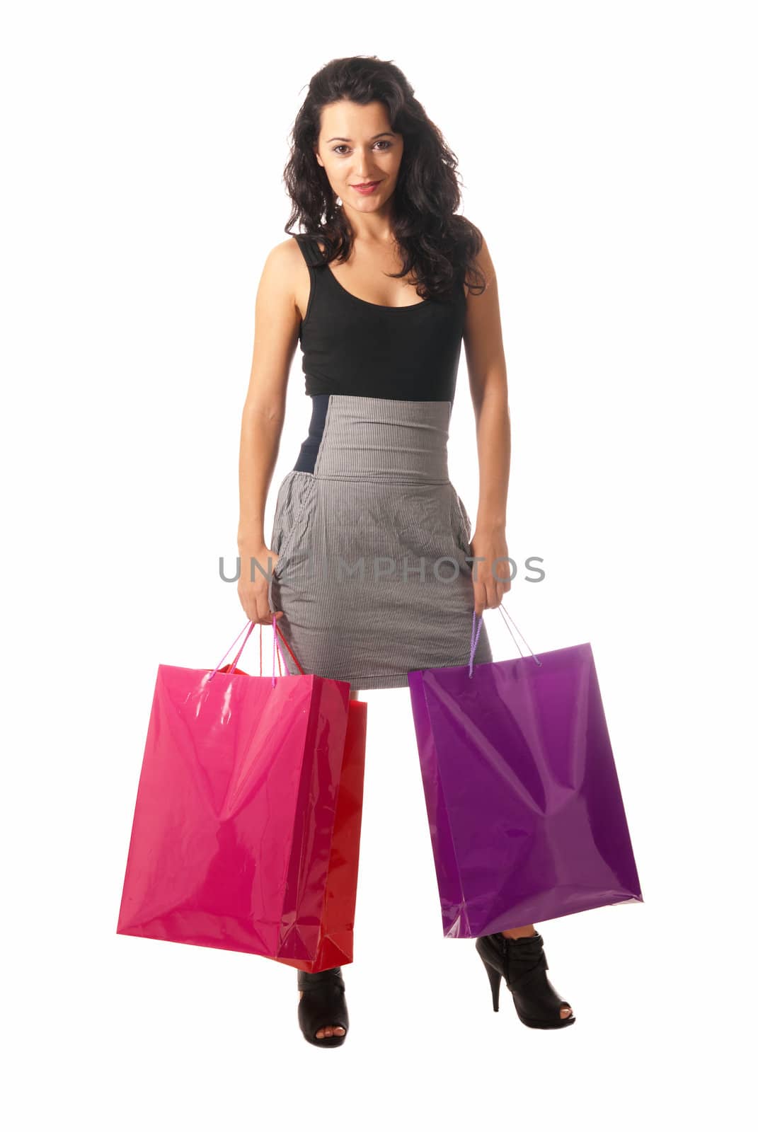 Young woman with shopping bags standing isolated on white background by dgmata