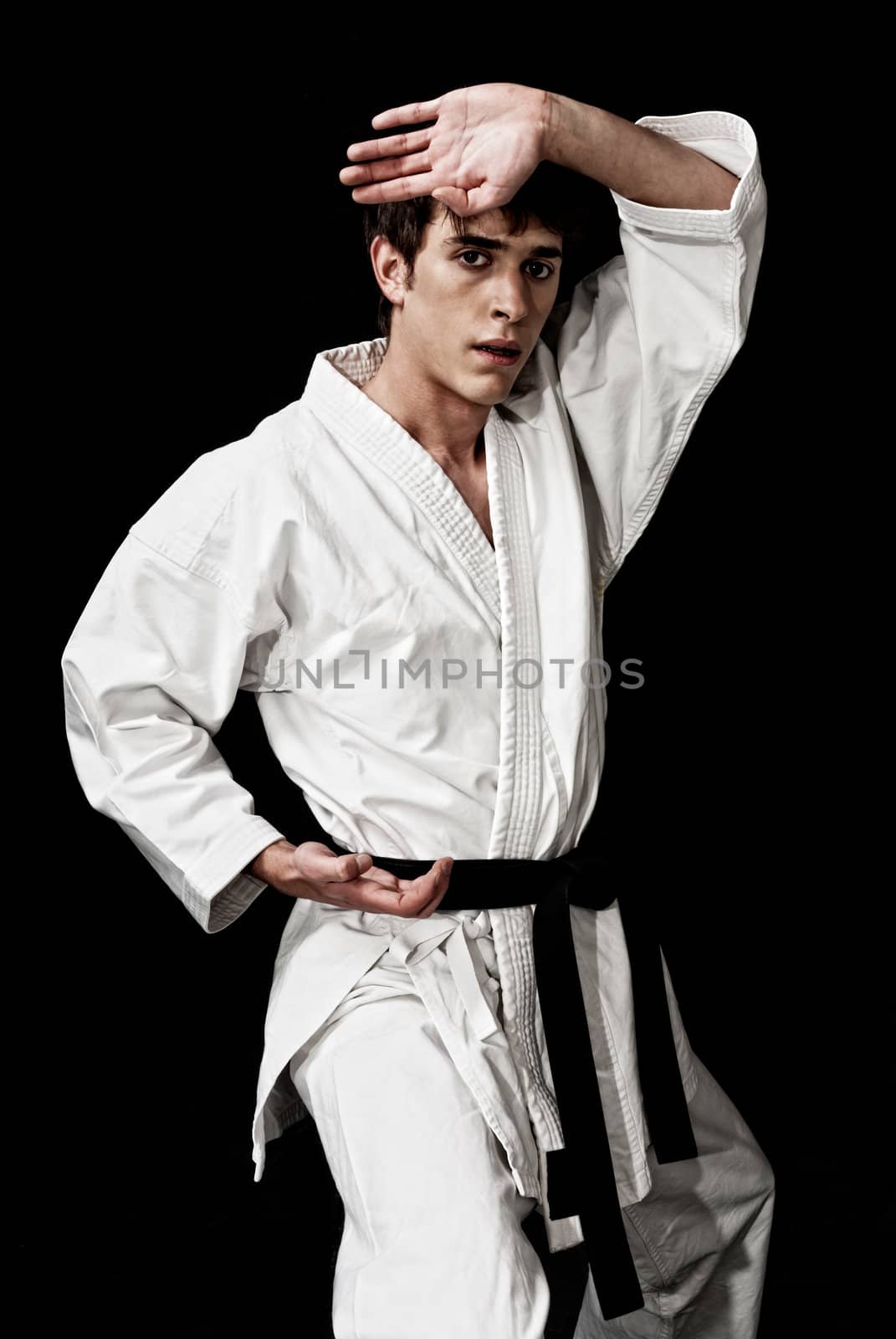 Karate male fighter young high contrast on black background