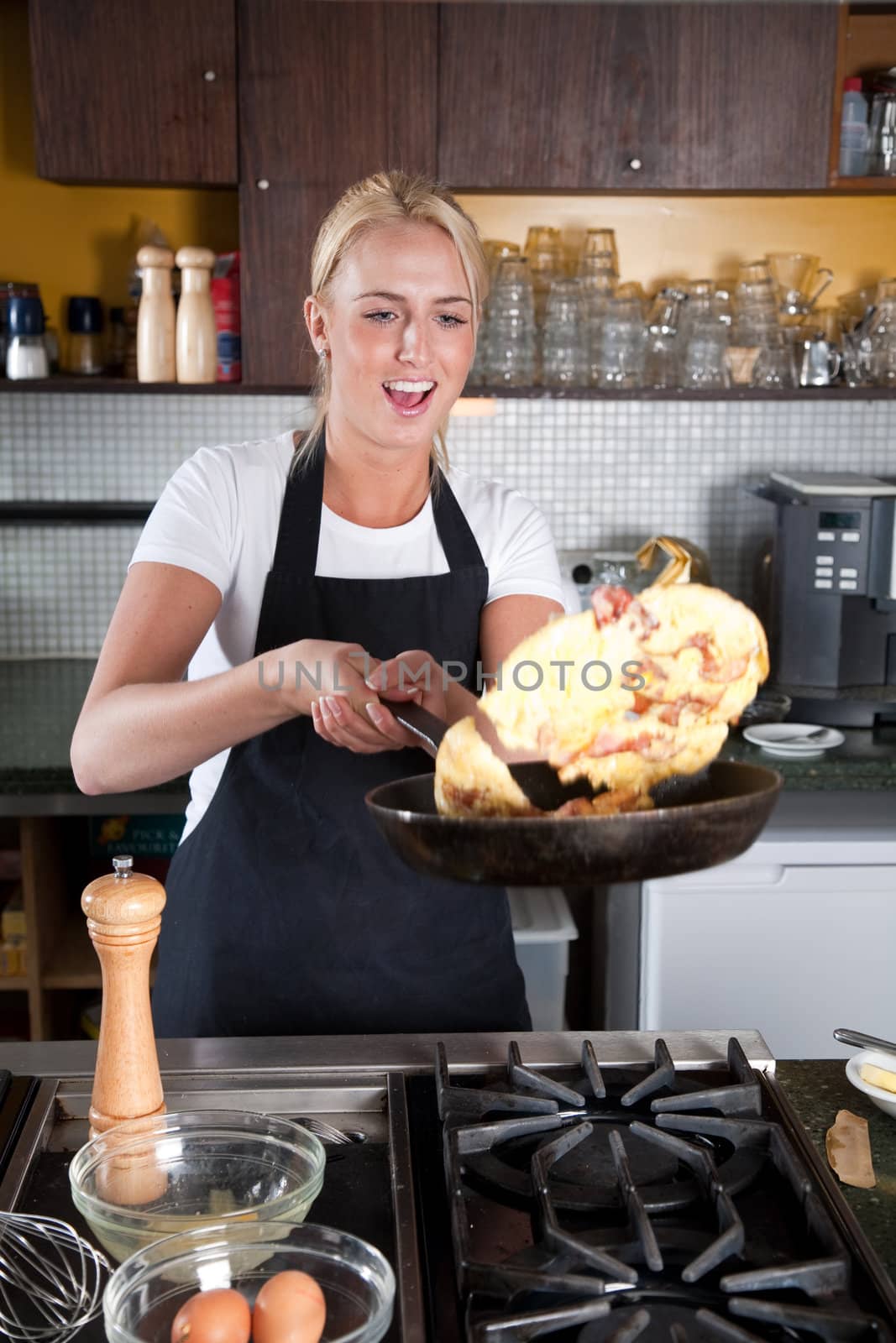 Female chef flipping the baked egg in the frying pan