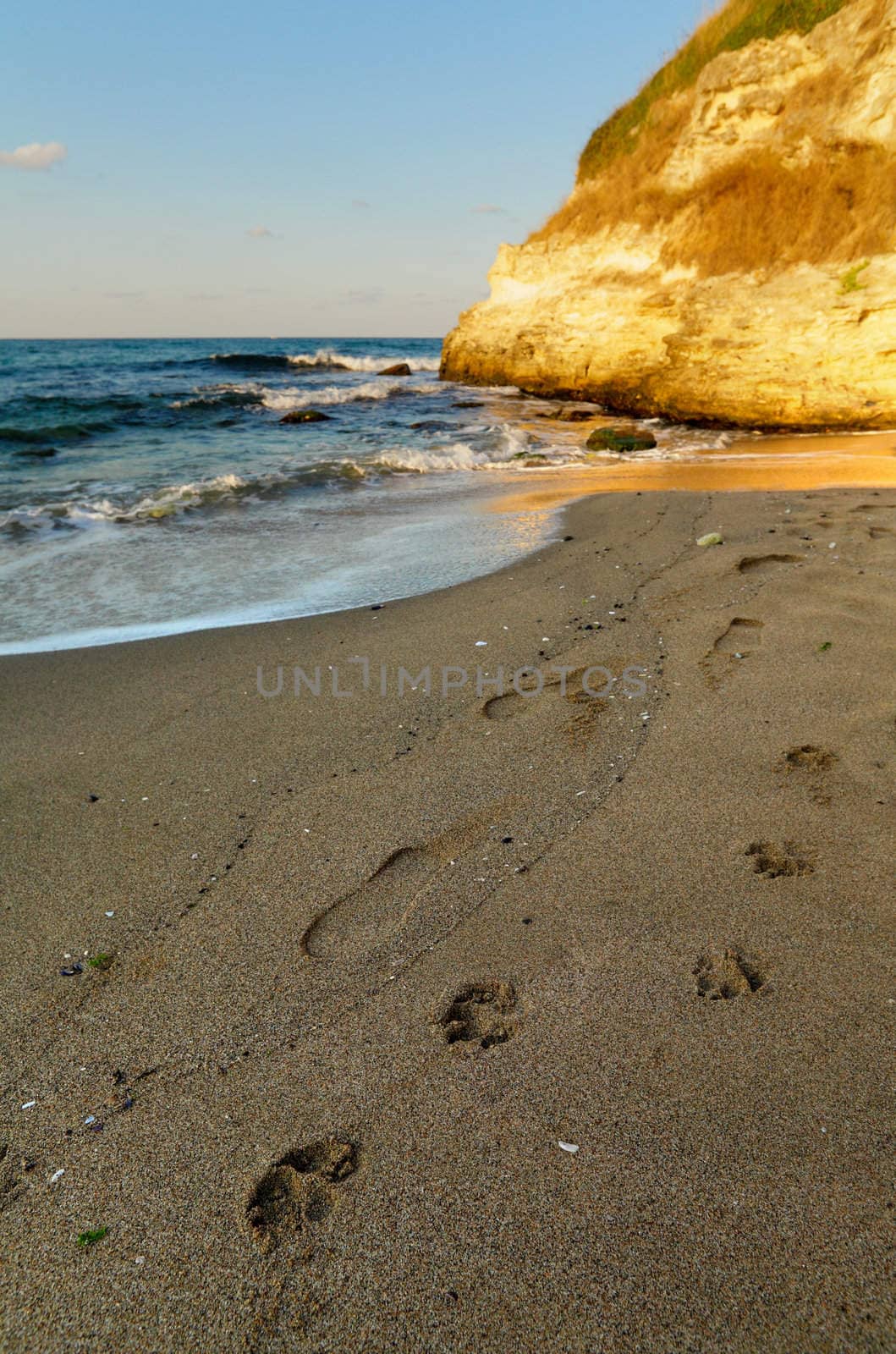 Signs on the beach sand at sunset