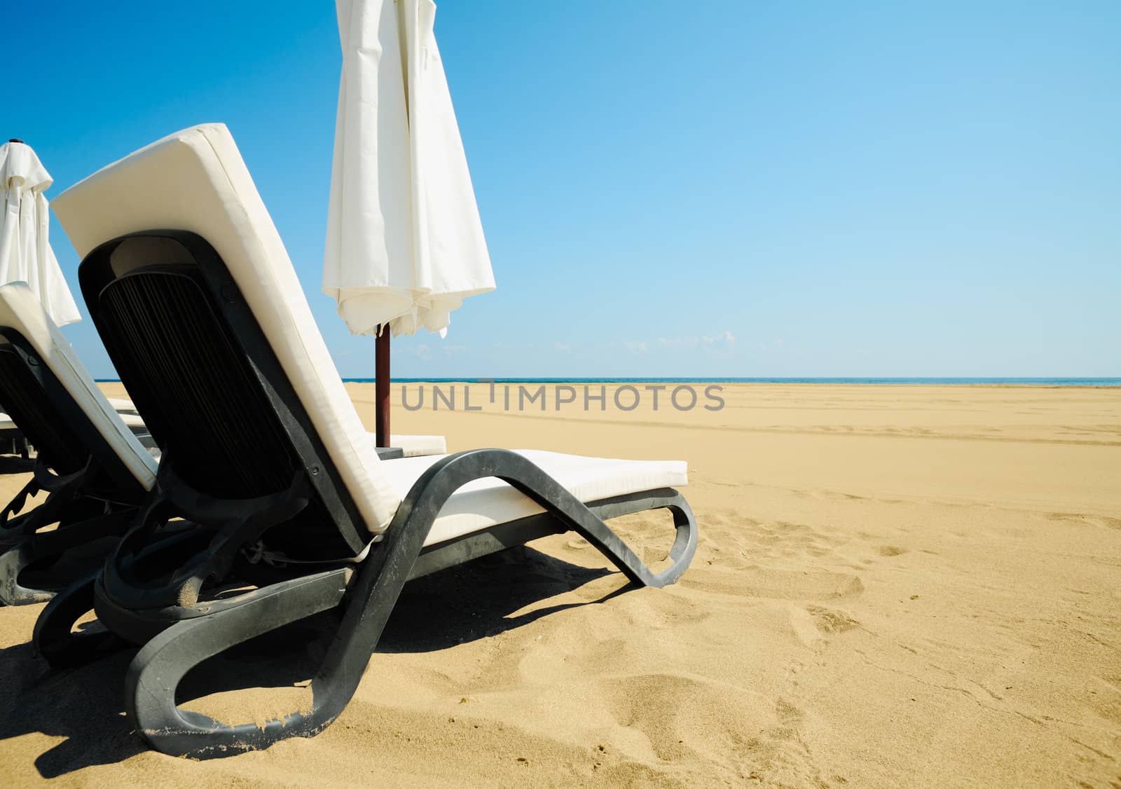 Relax chairs on a beach with golden sands