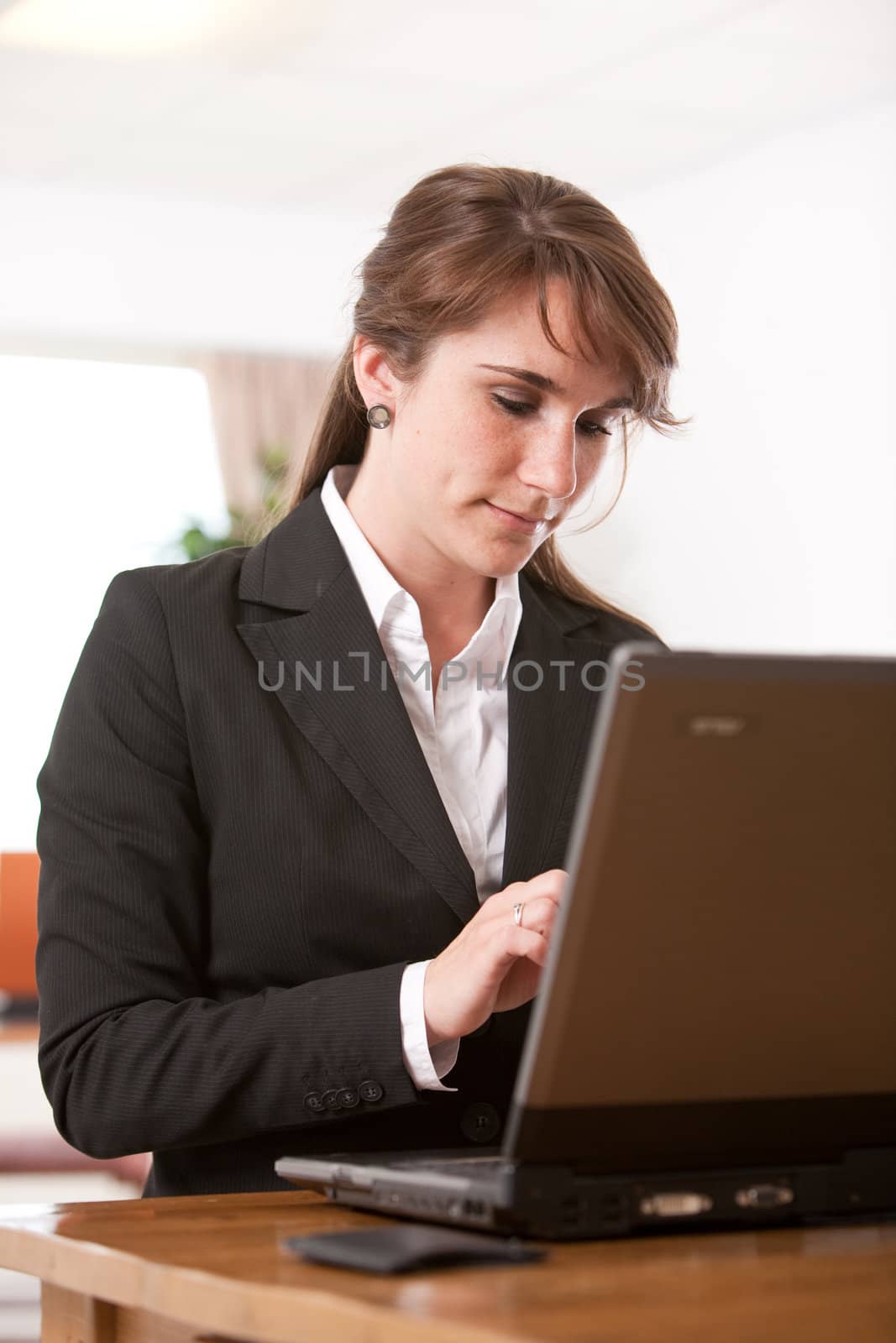 Attractive young woman working behind her laptop