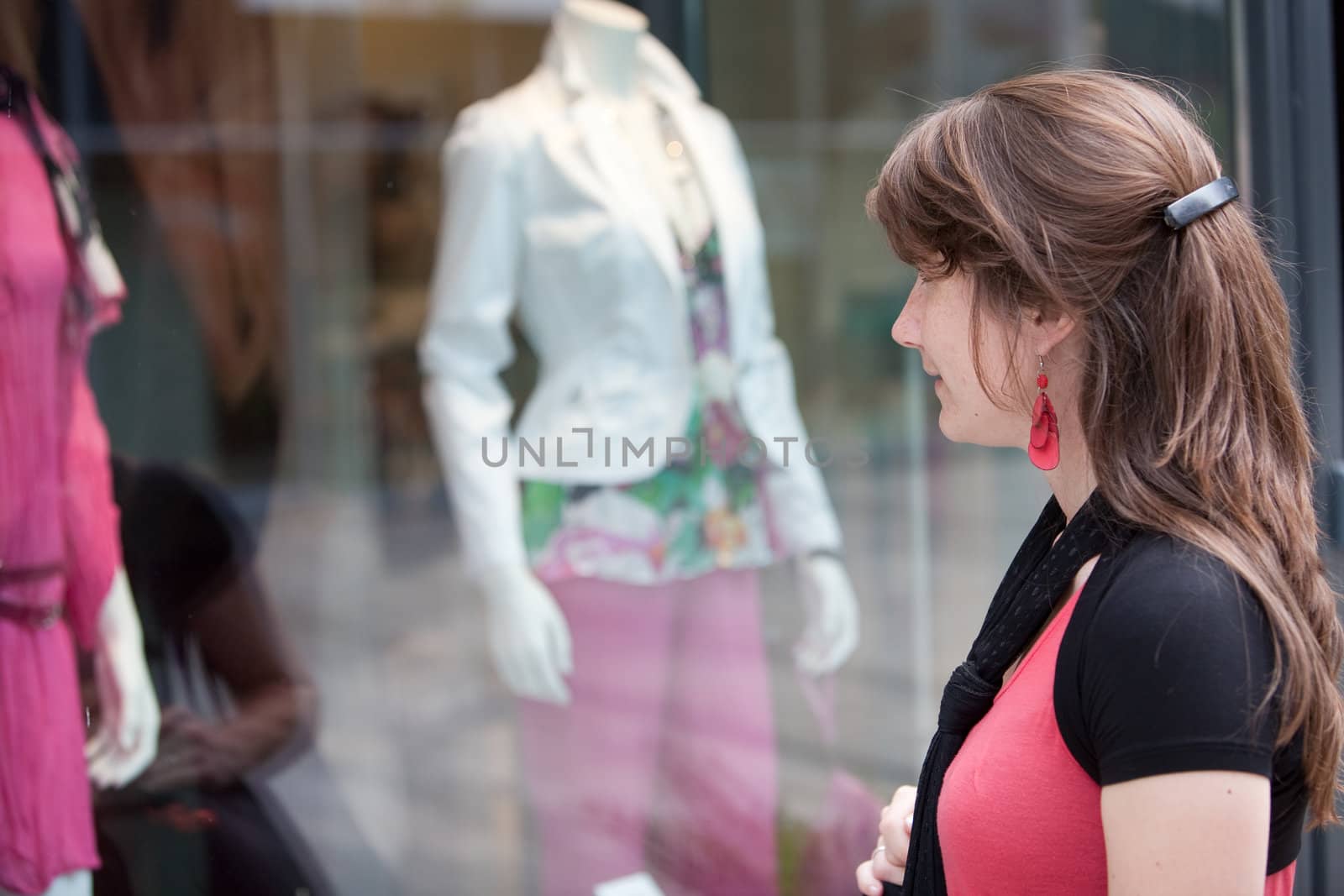 Attractive young girl checking out the window display