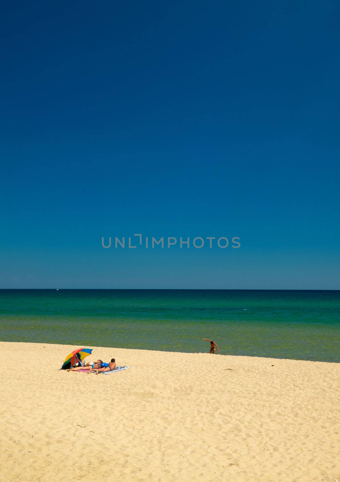 A couple taking sunbath on a beach at the Black sea coast, Bulgaria