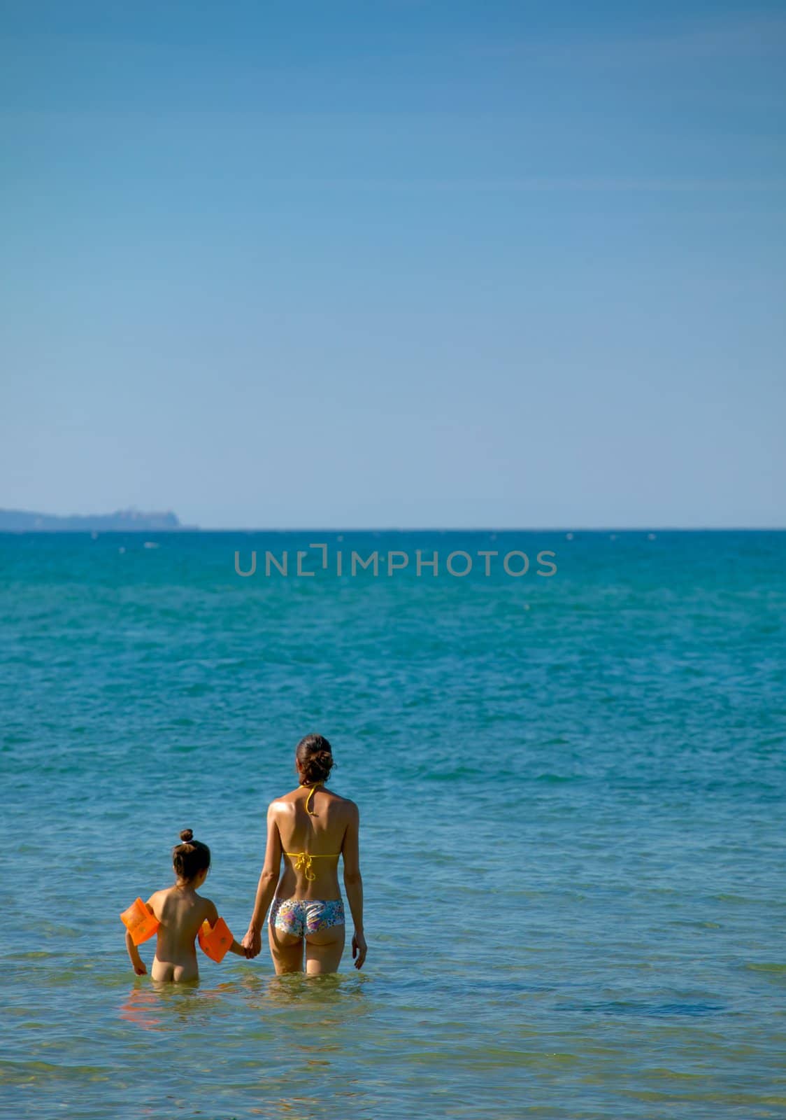 Mother and daughter in the sea water