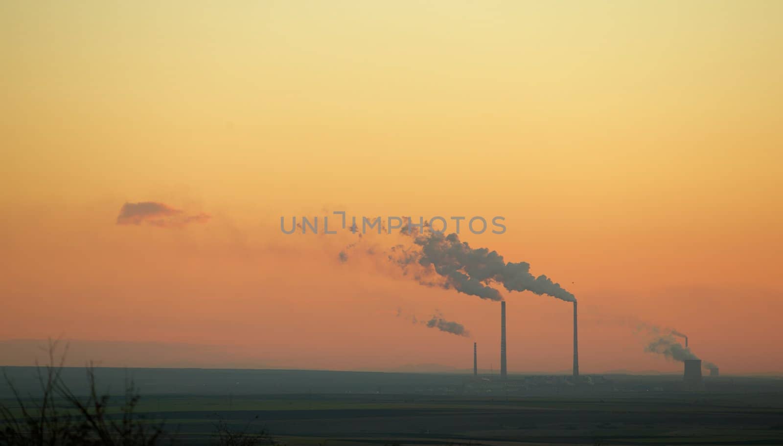 Electric plant emitting smoke in atmosphere