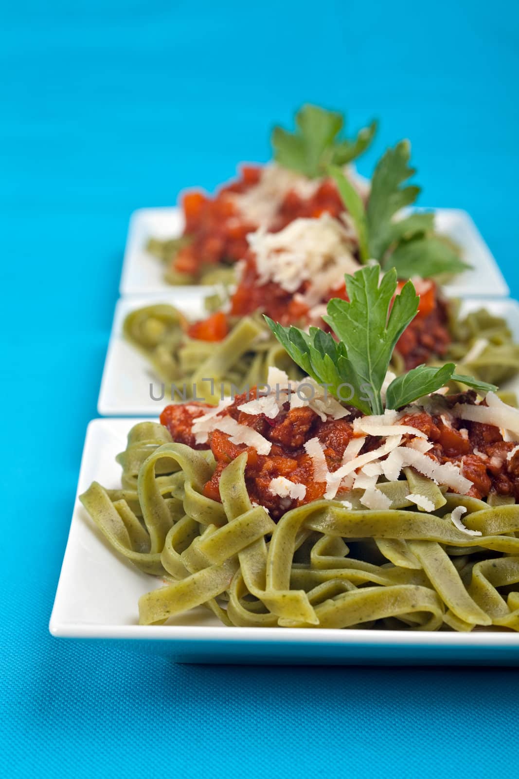 tagliatelle with sauce bolognaise in white plates