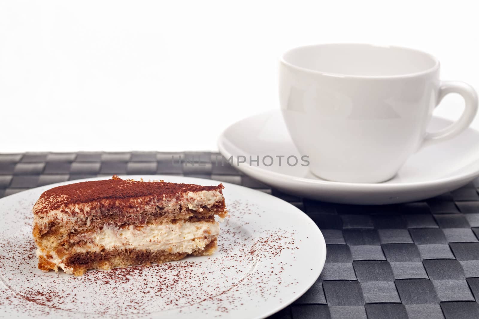 slice of a tiramisu cake on a white plate by bernjuer