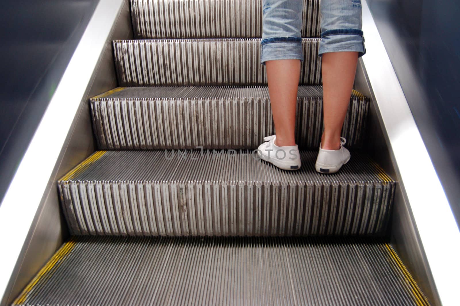 Woman on escalator leading up