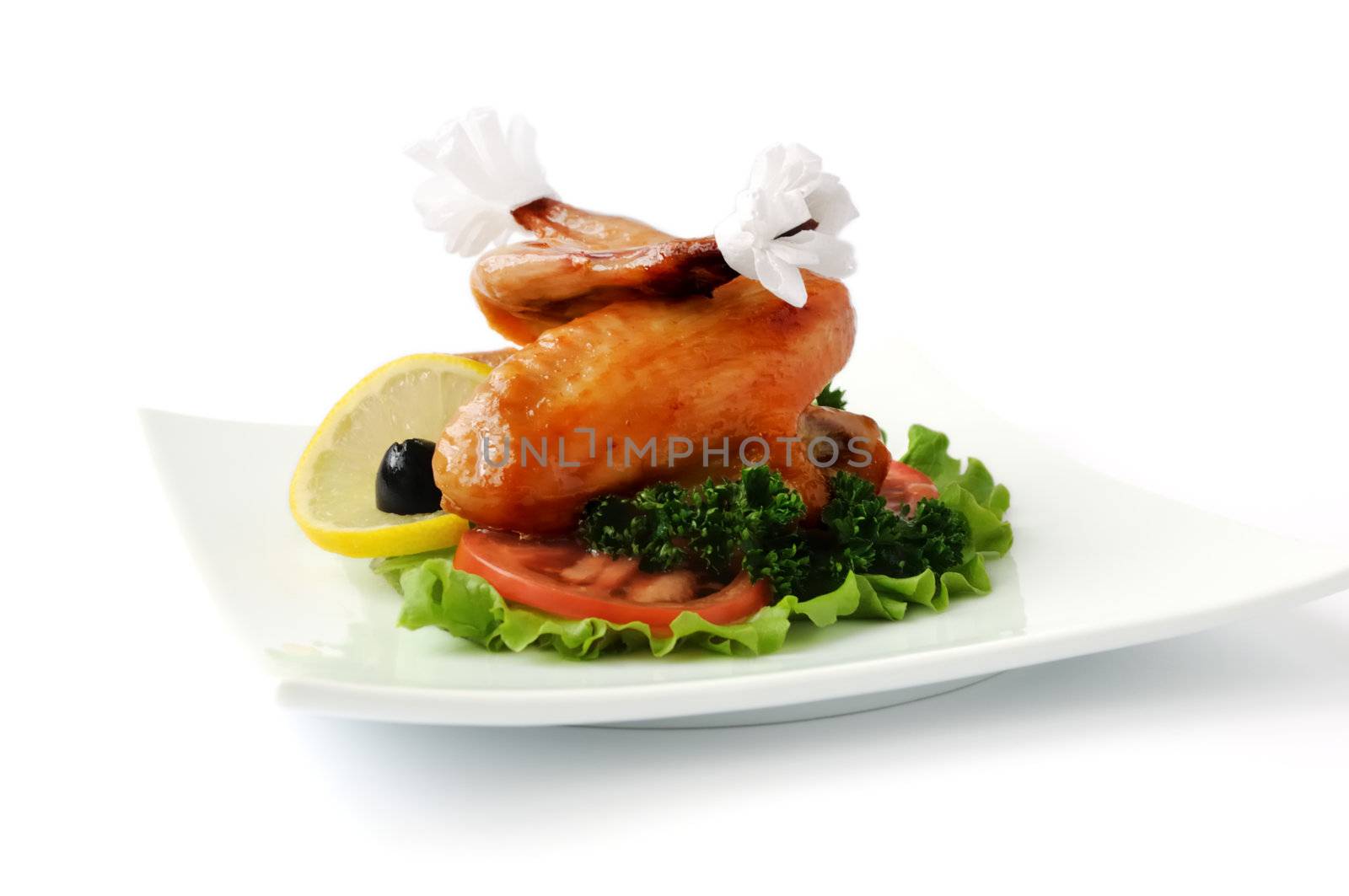 Fried chicken wings with tomato on white background