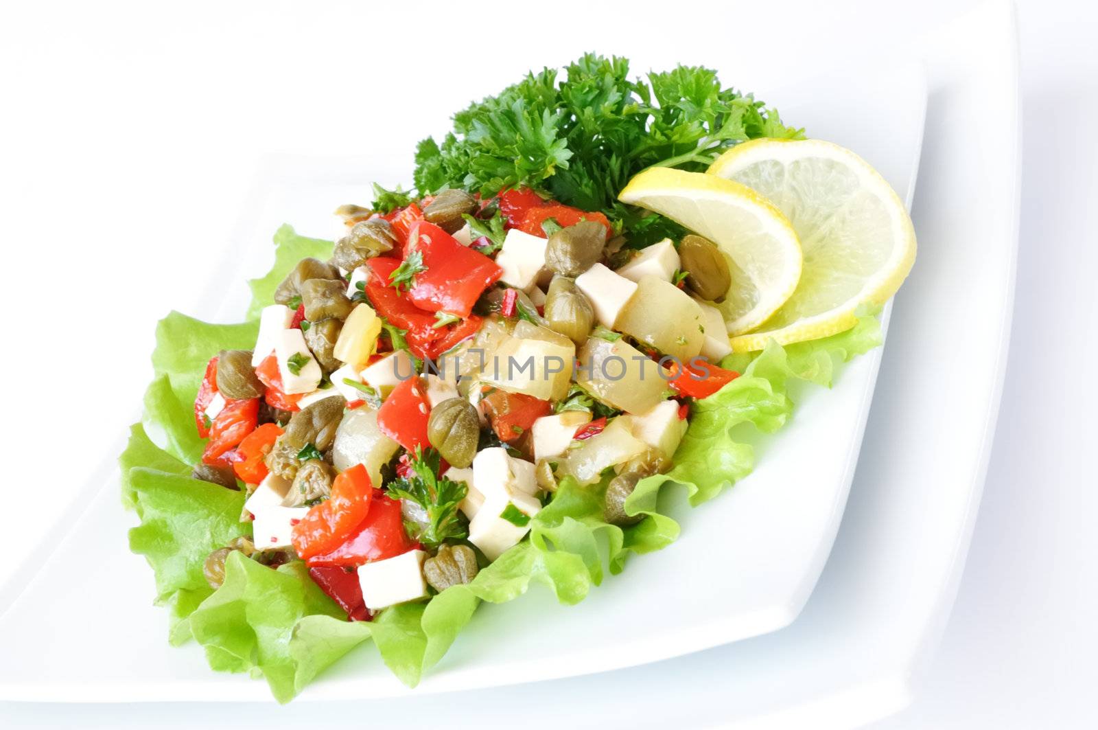 A salad of red peppers with goat cheese, capers, fresh herbs in the marinade