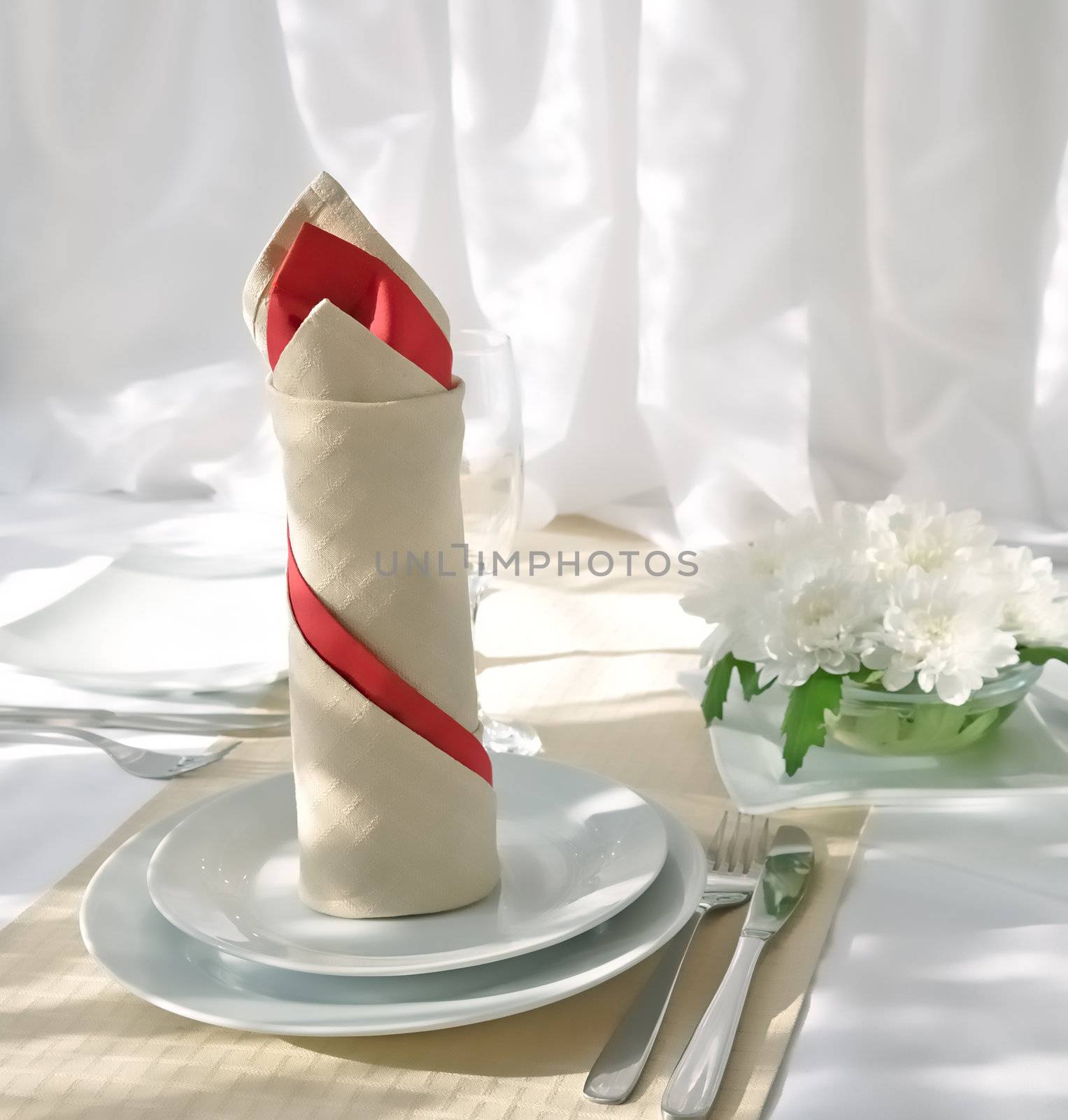 Coordinated decorative napkin on a plate with cutlery