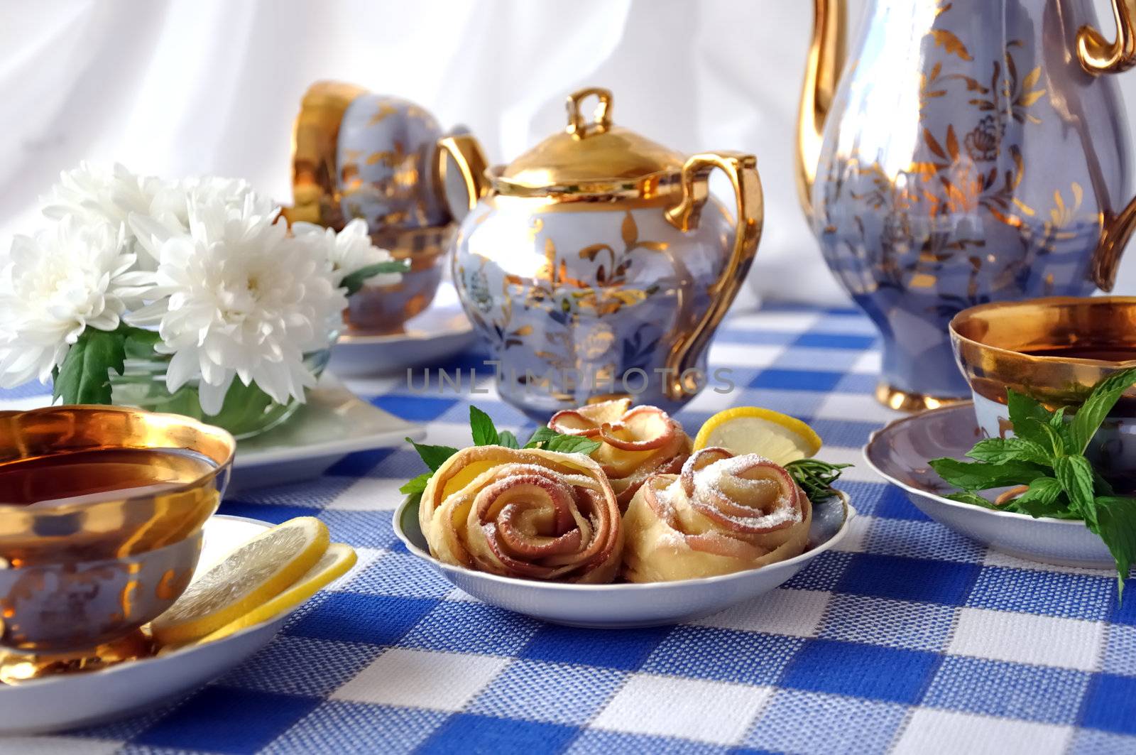 Rosettes of the apples and dough with powdered sugar to the tea table