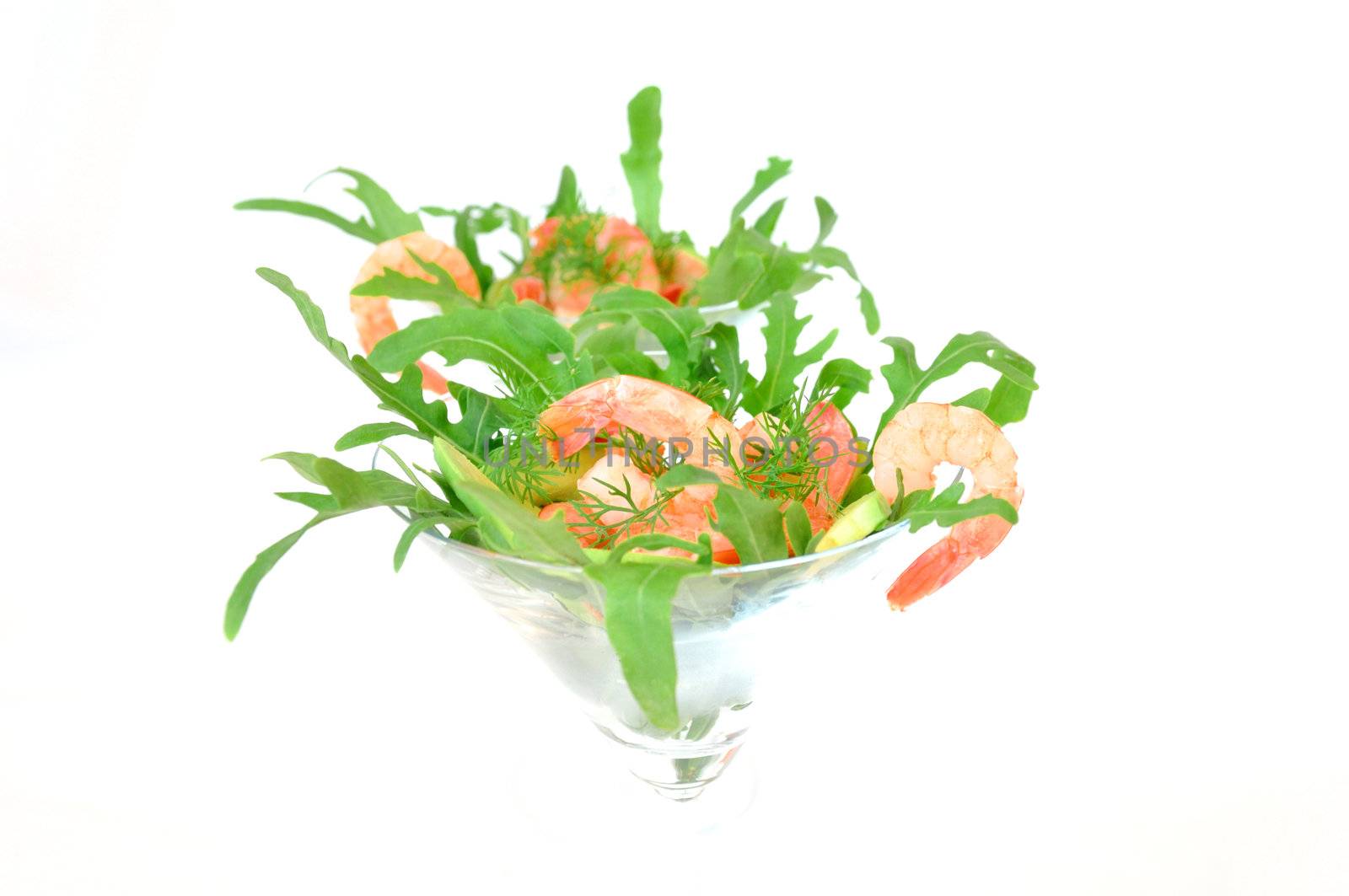 Shrimp in a glass with avocado and arugula close