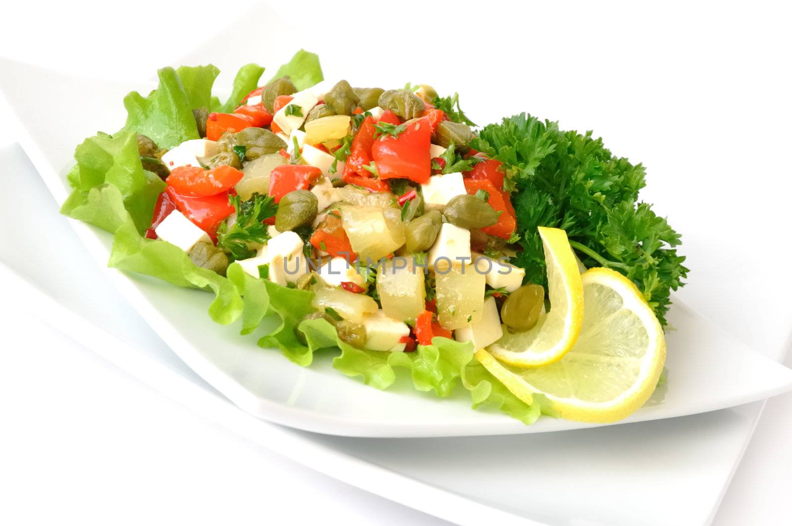 A salad of red peppers with goat cheese, capers, fresh herbs in the marinade