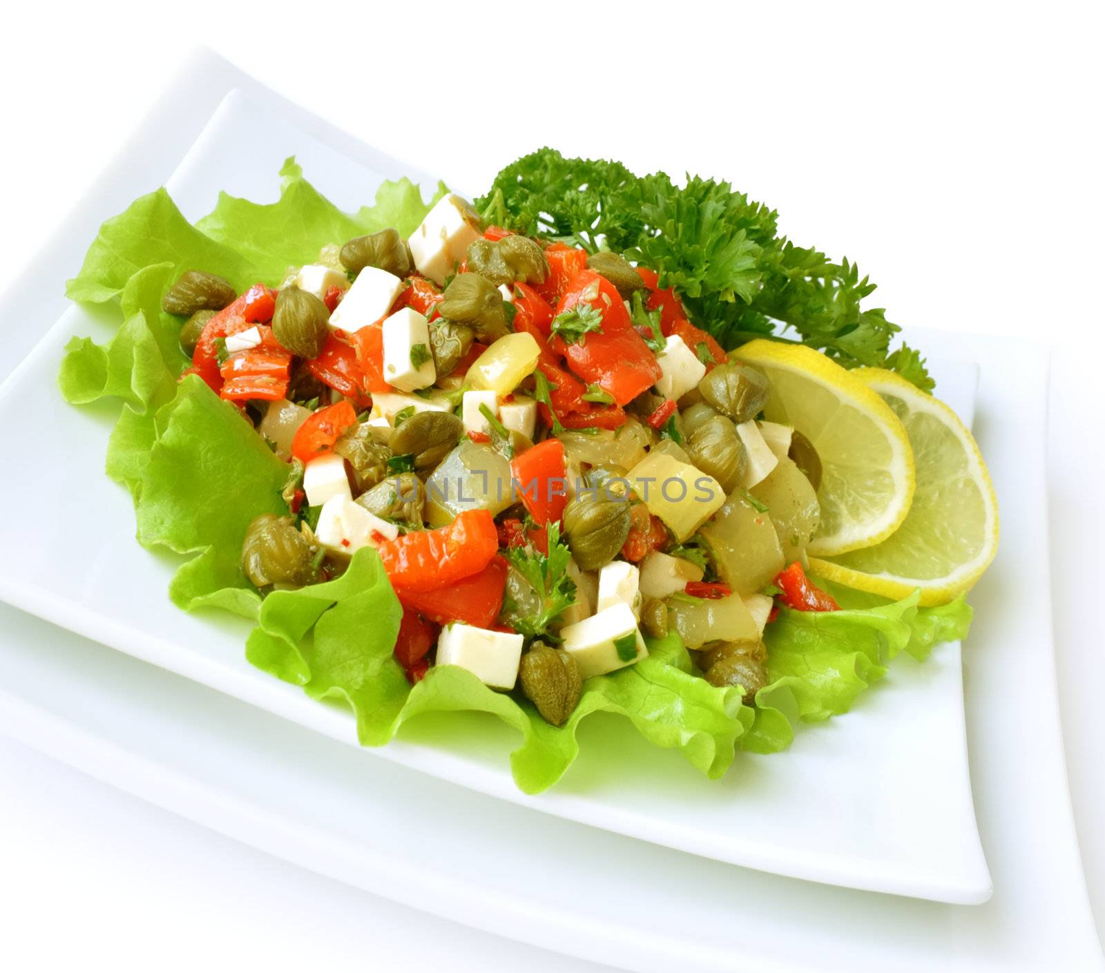 A salad of red peppers with goat cheese, capers, fresh herbs in the marinade