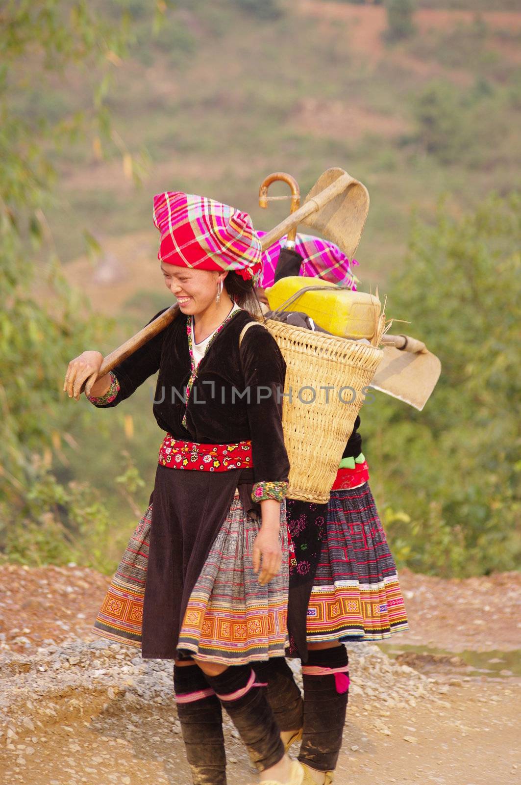 Two young women returning from the fields. Their dress is not folklore they wear daily to work
