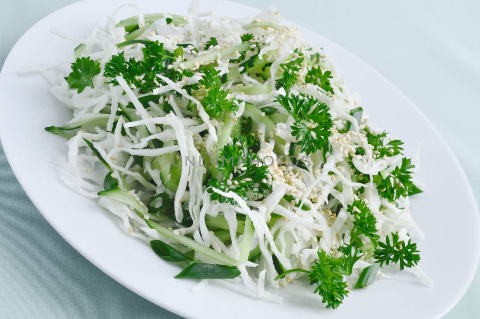 Salad of fresh cabbage and cucumber with herbs and sesame by Apolonia