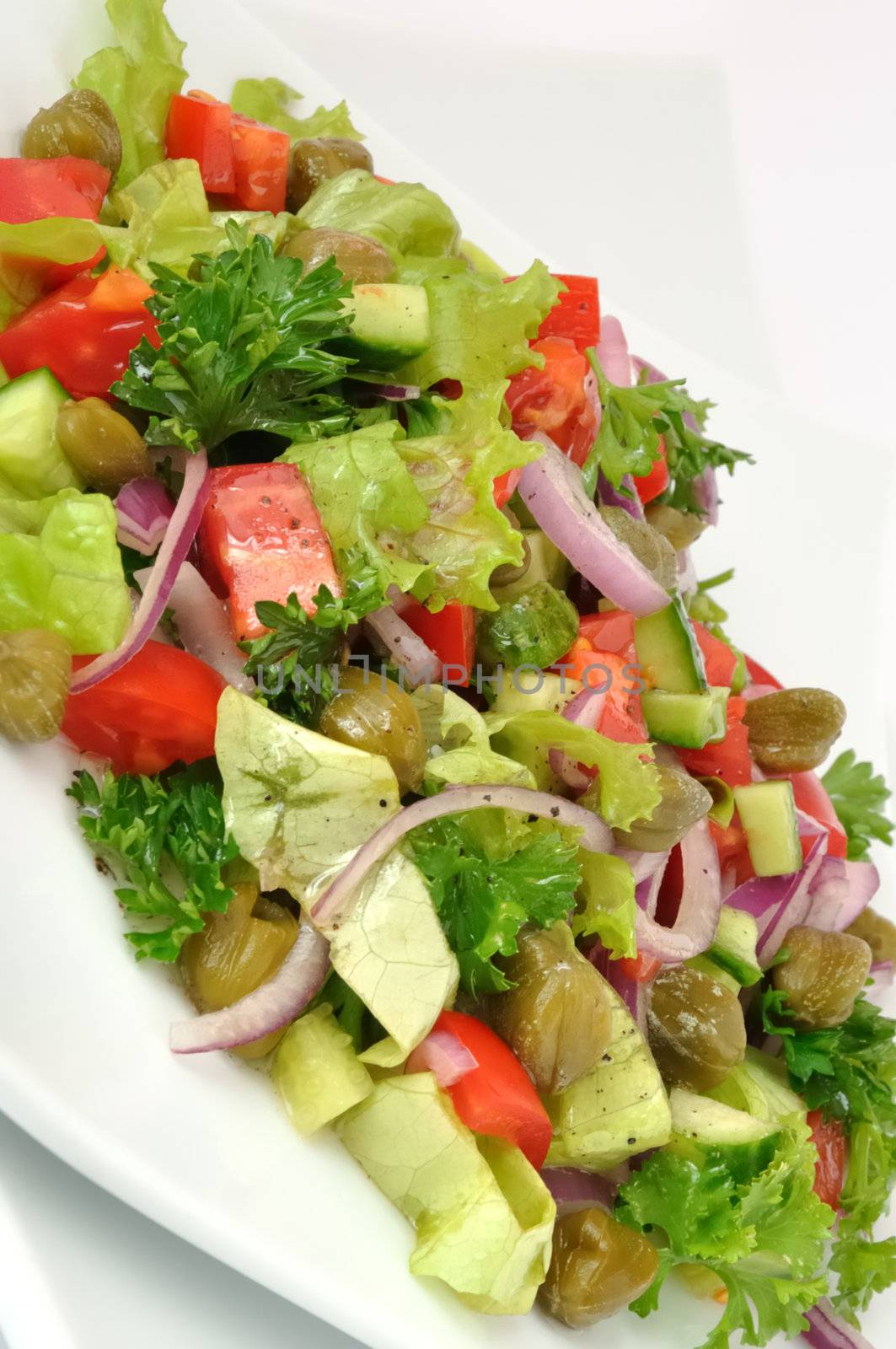 Vegetable salad with capers and herbs close	