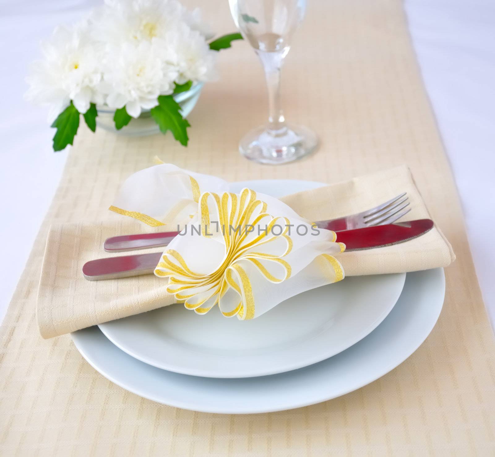 Coordinated decorative napkin on a plate with cutlery