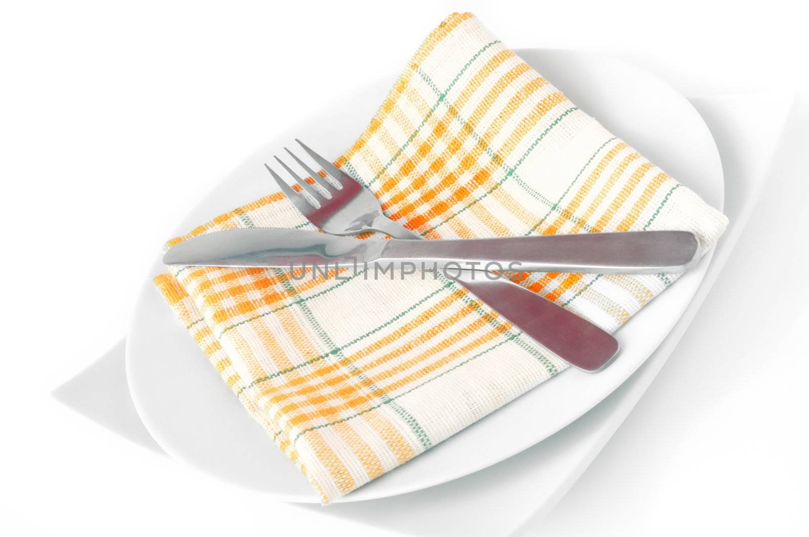 Napkin, folded on a plate with knife and fork c isolated	