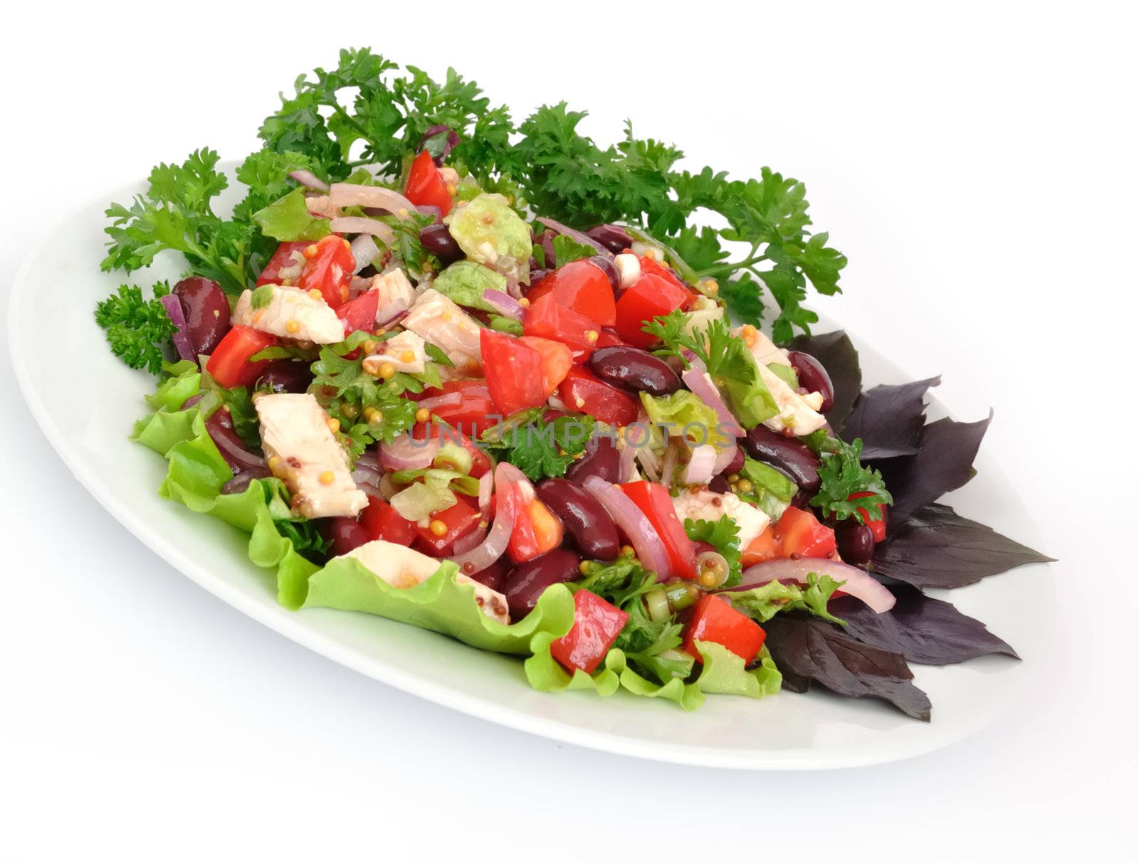 Salad with beans, tomatoes and chicken breast, lettuce, onions in mustard sauce with garlic
