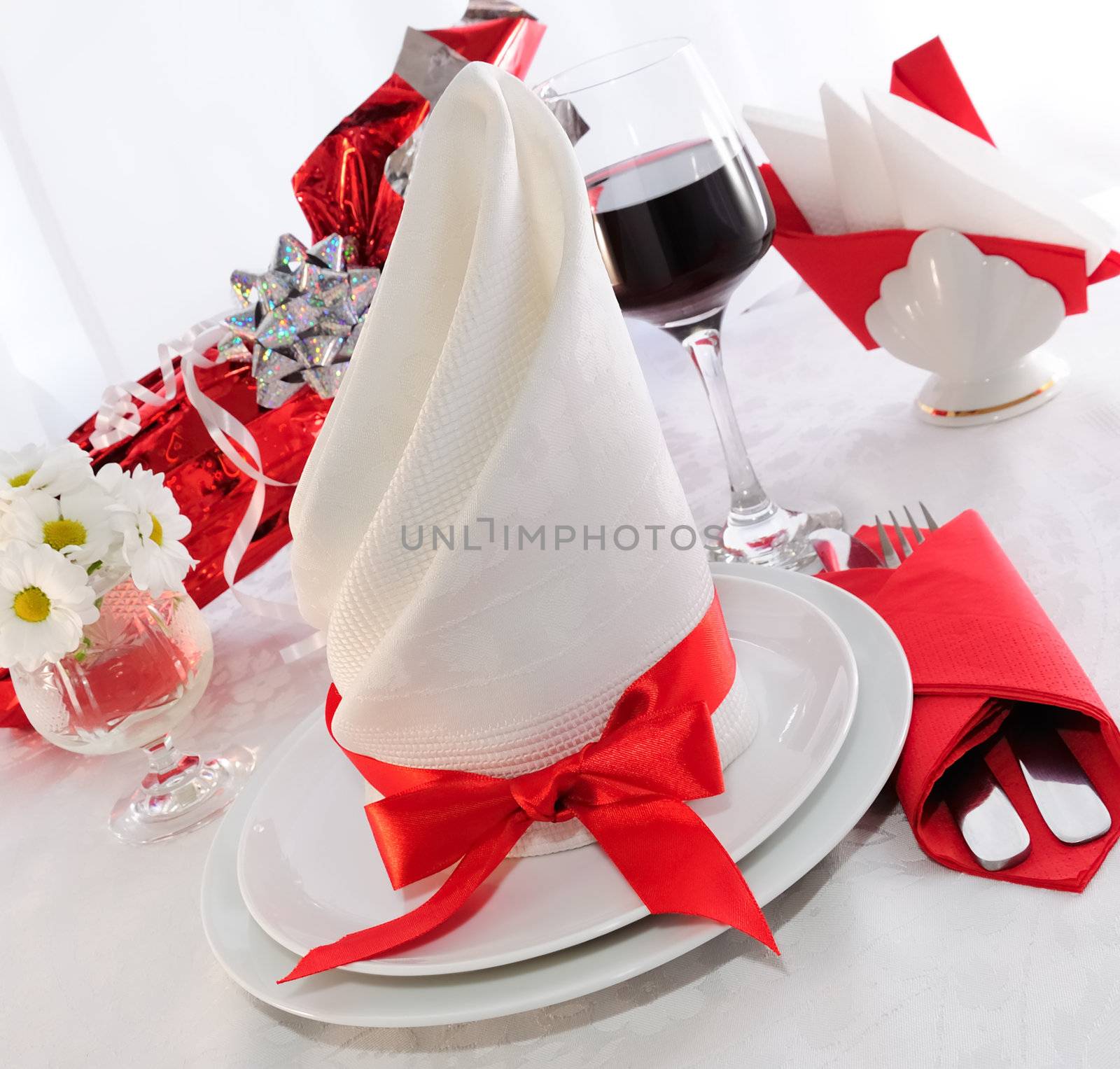 Table setting for a holiday napkin, flowers, wine