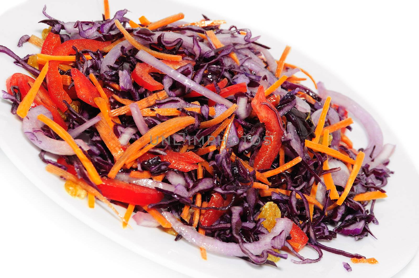 Salad of blue cabbage with carrots, peppers and raisins