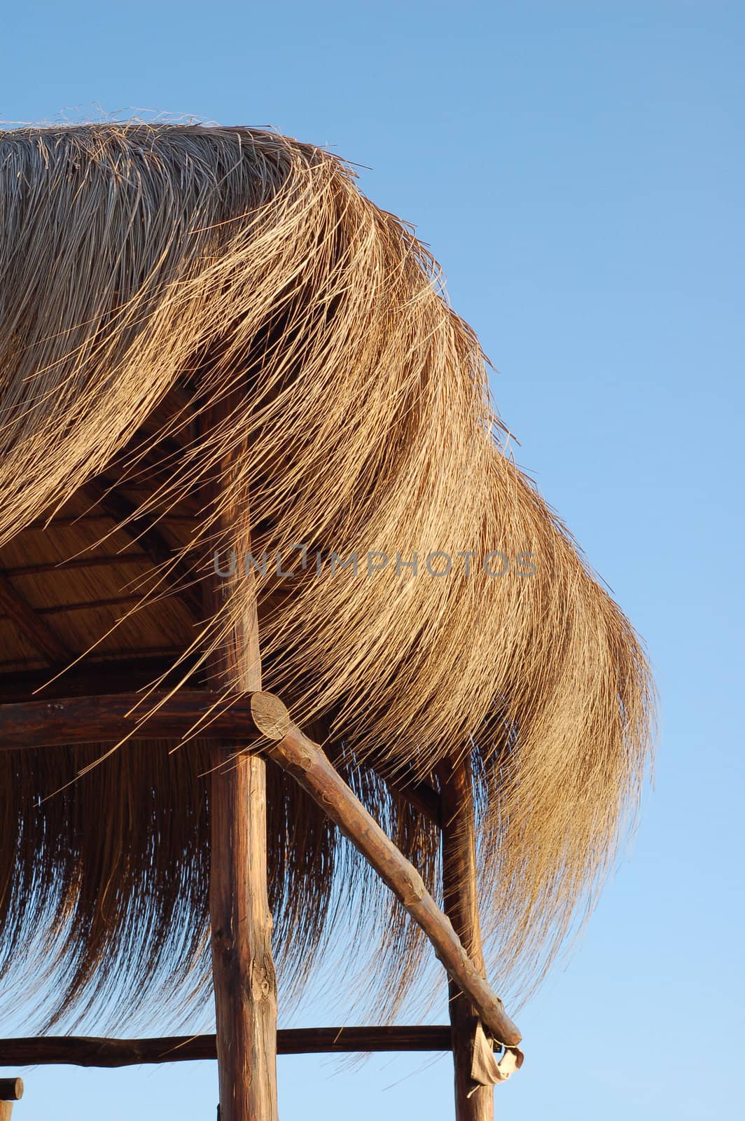 straw hut on blue sky - summer time background