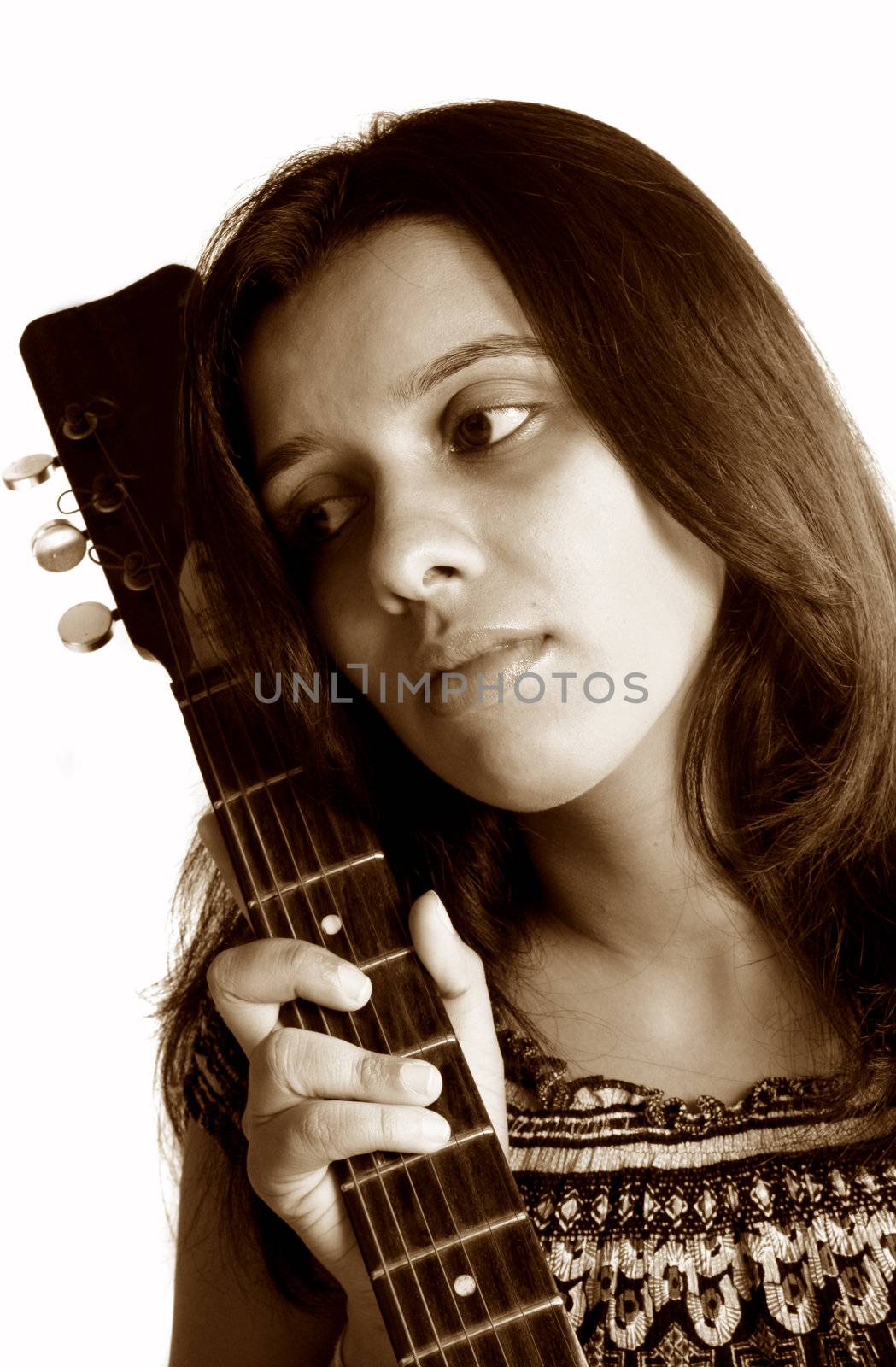 A portrait of a beautiful indian guitarist lost in her dreams.