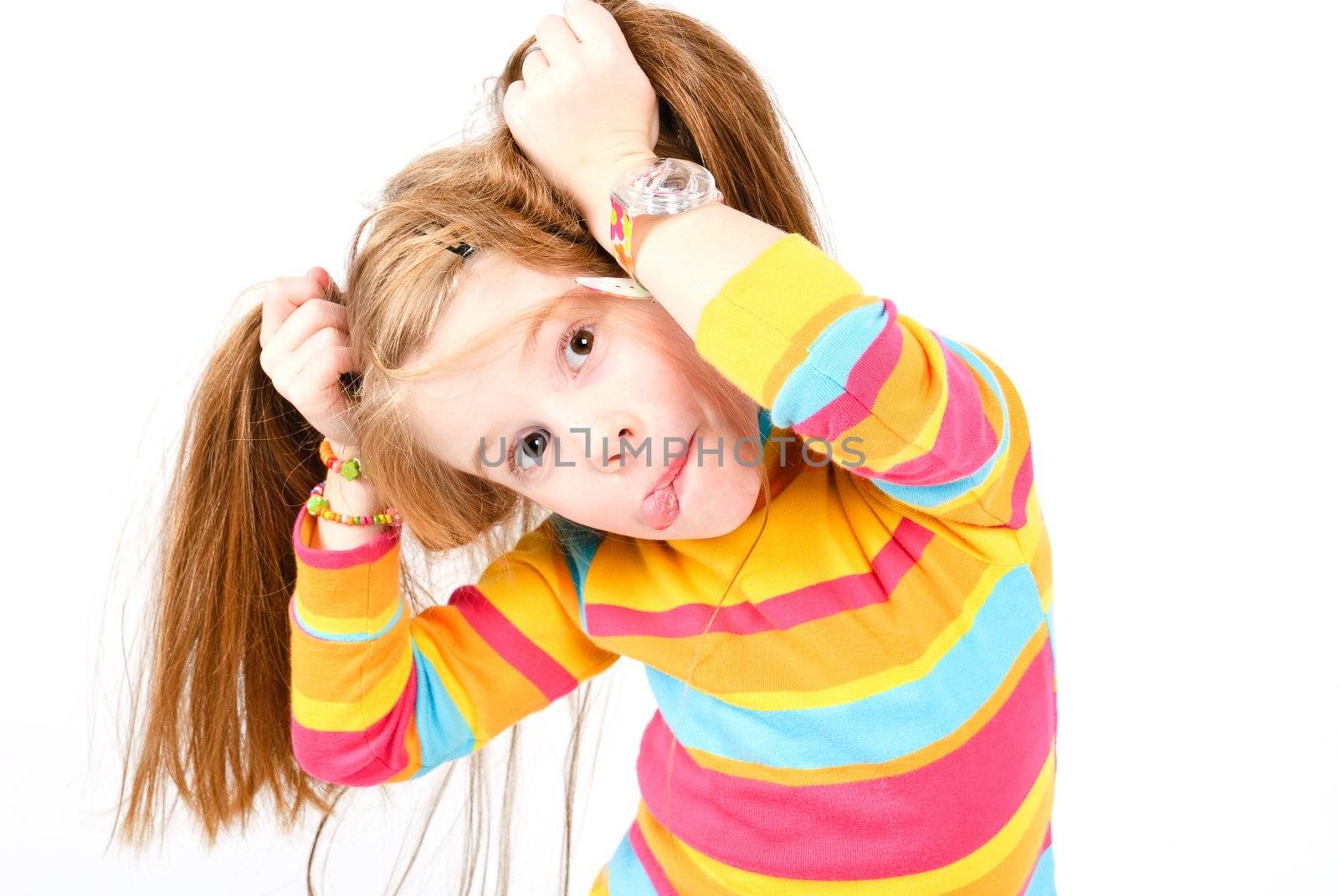 studio shot of pretty little girl with a fun grimace