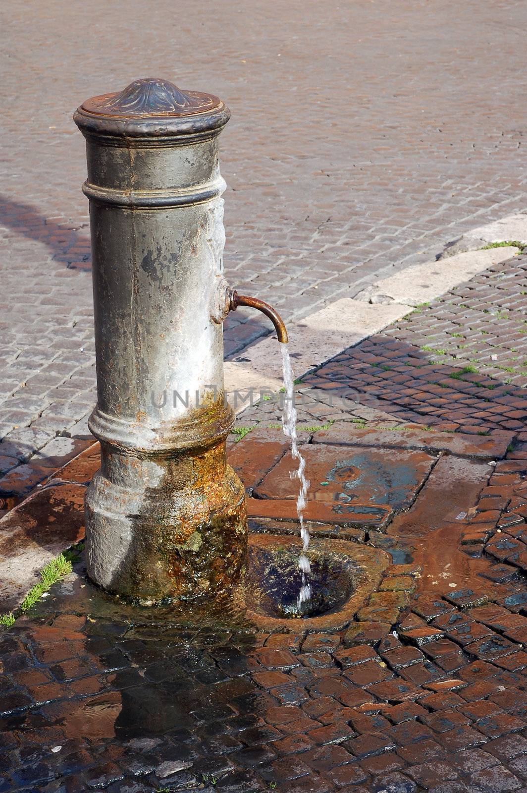 "Big Nose" fountain. Detail - Classic roman free water public fountain. Rome Italy