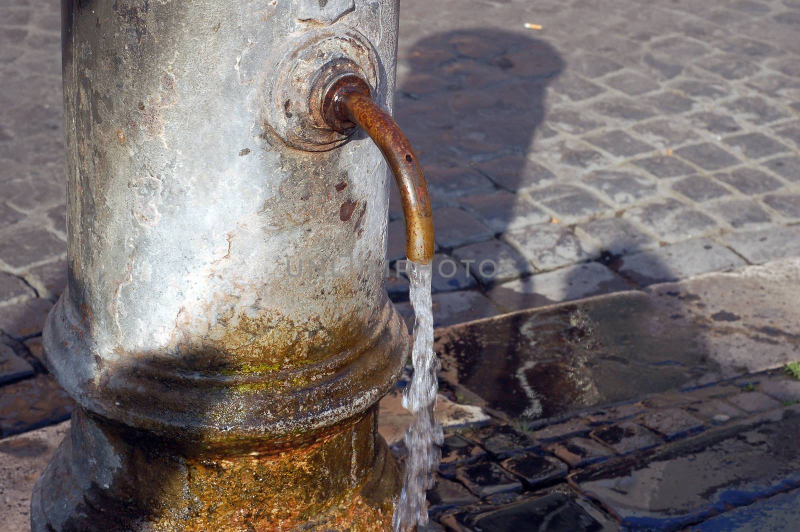 �Big Nose" fountain. Detail - Classic roman free water public fountain. Rome Italy