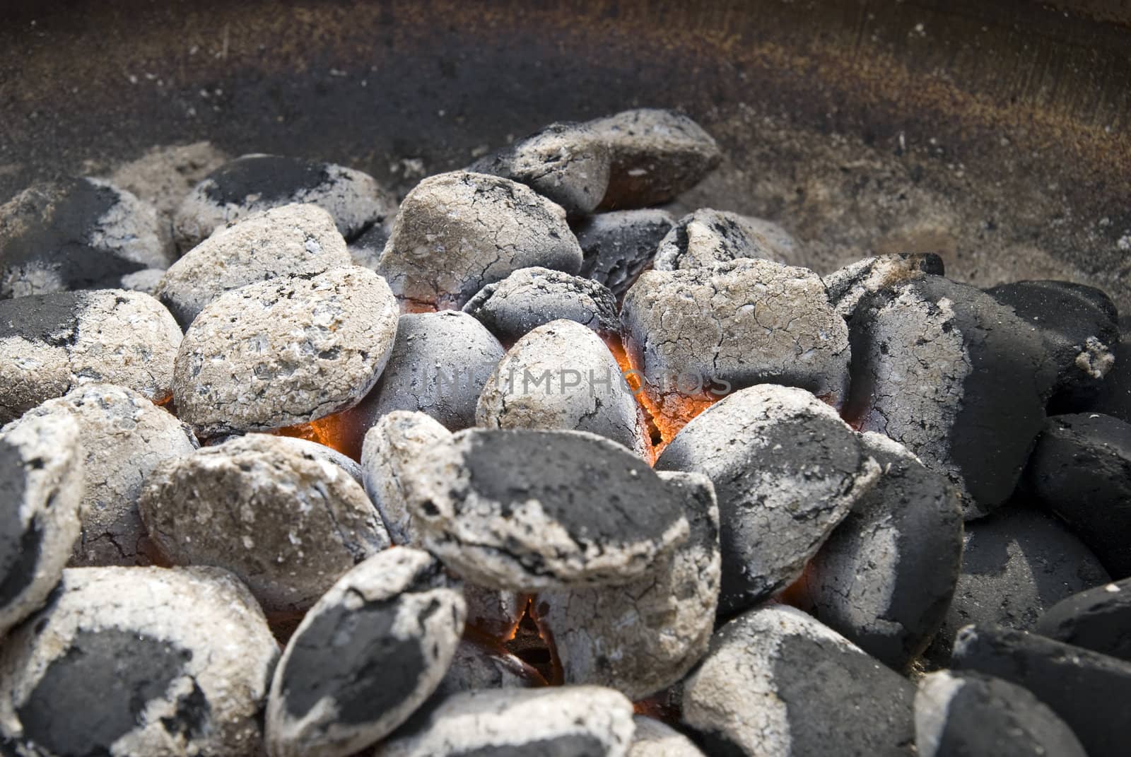 A hot barbecue grill with glowing coals.