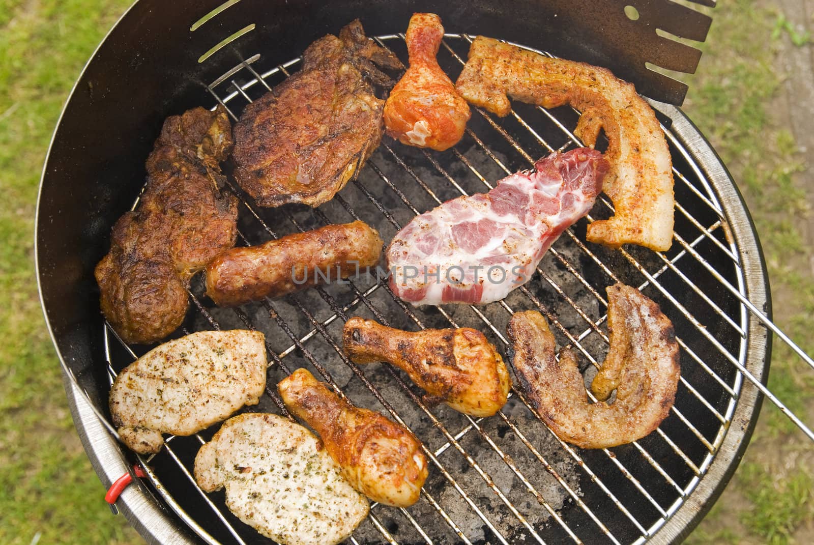 Sausages, beef and other meat on a barbecue