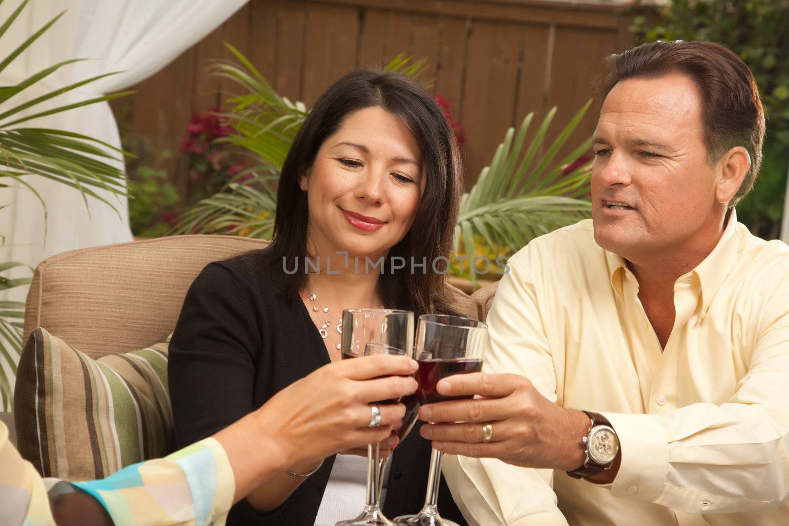 Three Friends Enjoying Wine on an Outdoor Patio.