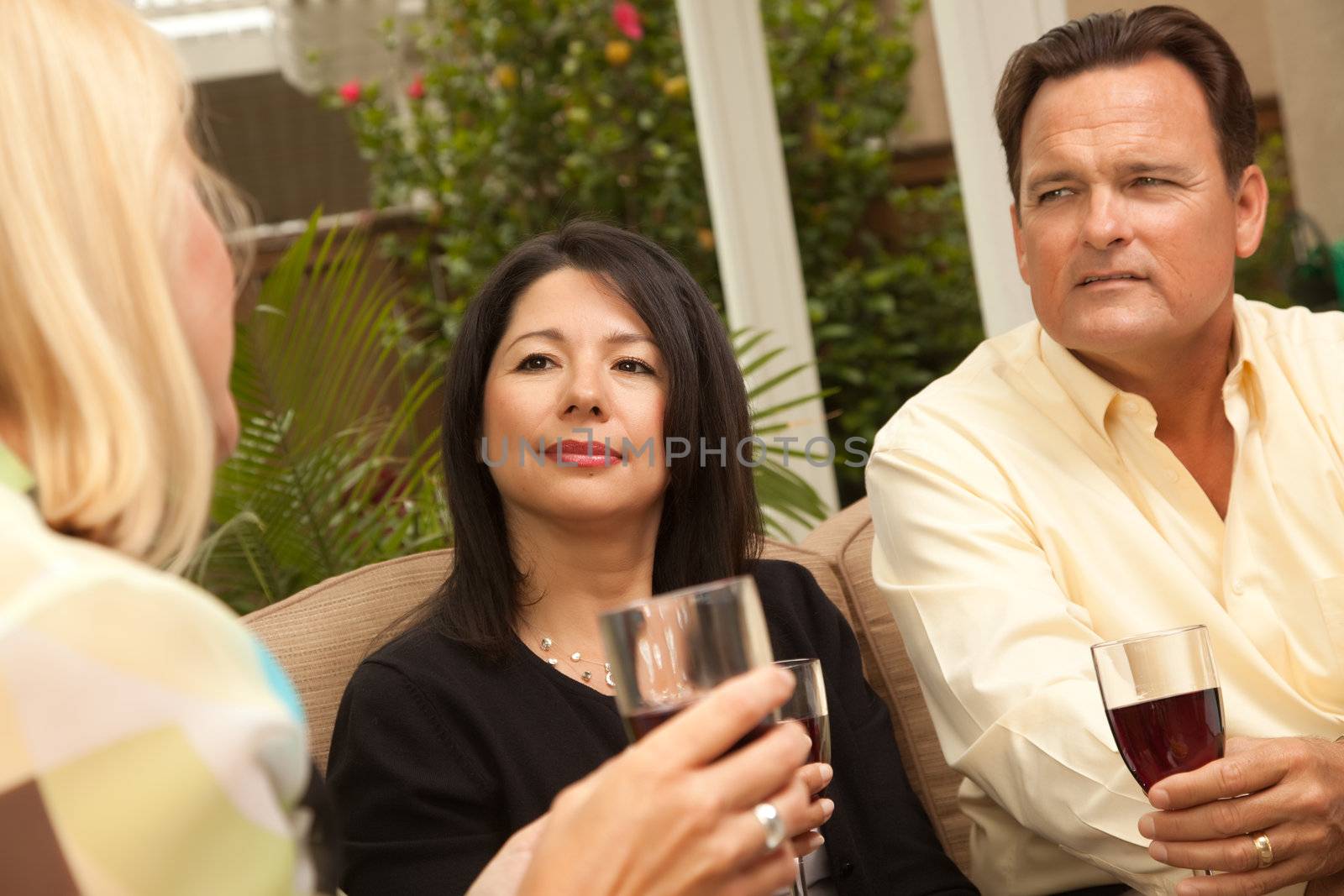 Three Friends Enjoying Wine on the Patio by Feverpitched