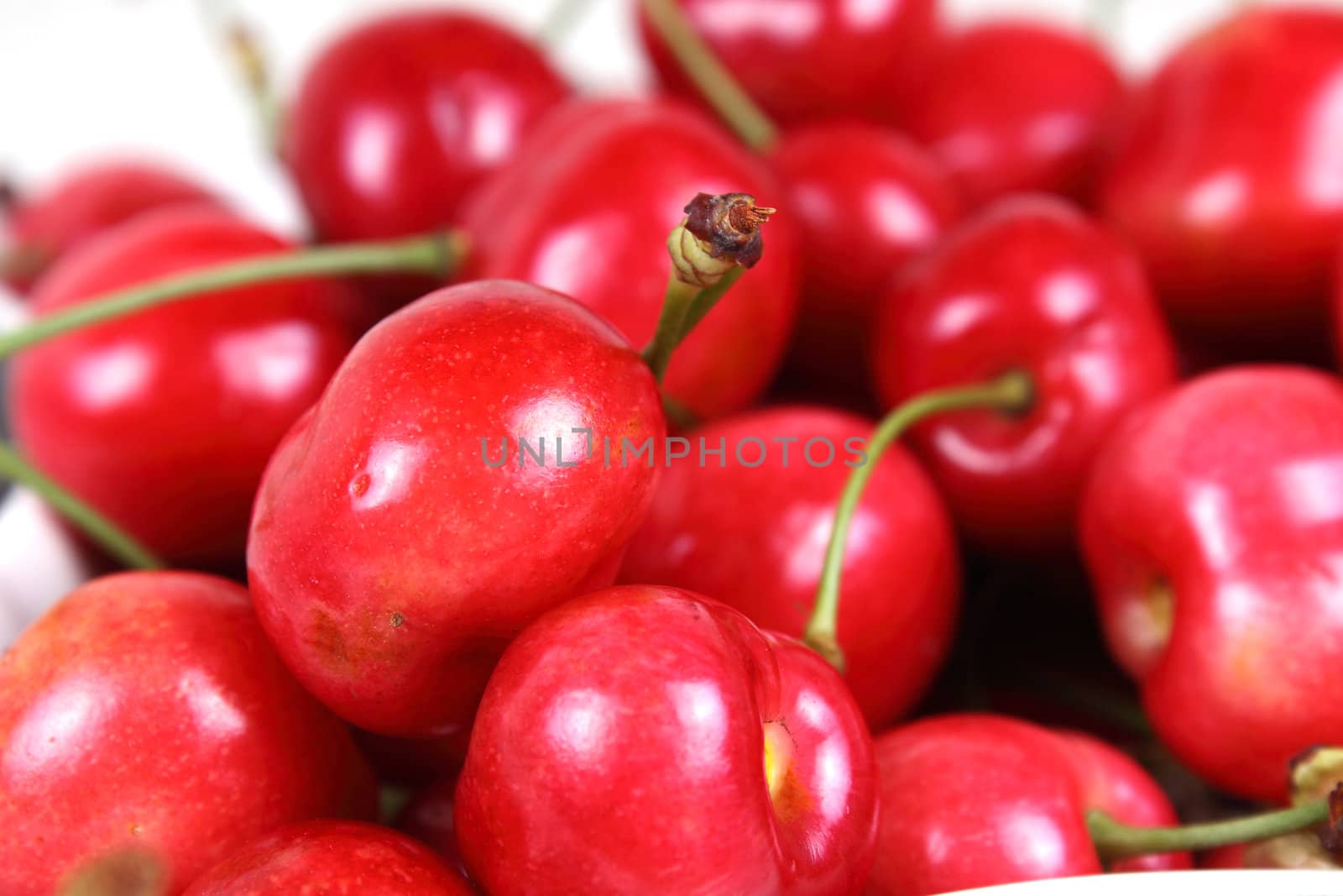 Shot of fresh ruby cherries on white background