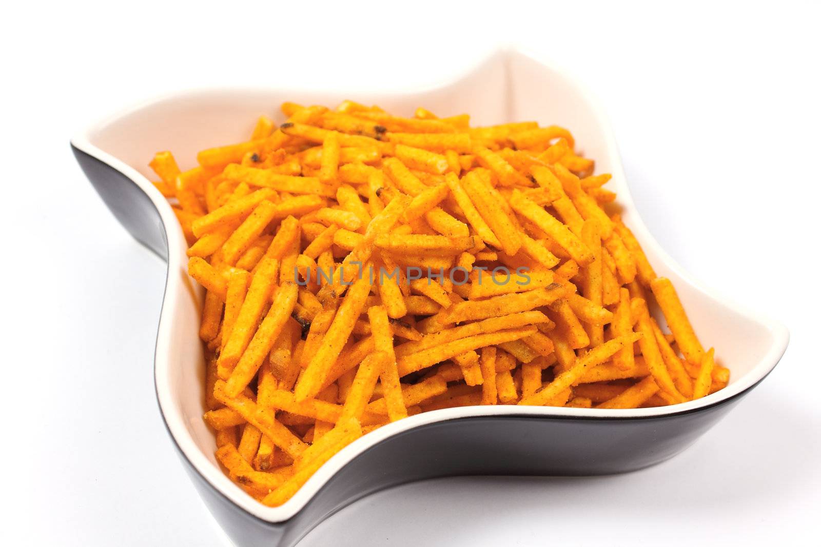 Shot of delicious snacks on brown bowl on white background