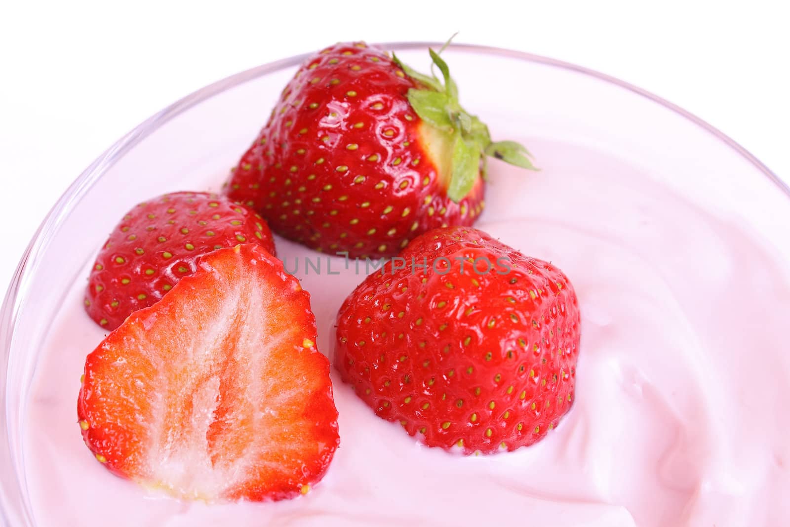 Fresh strawberries in fruit yogurt isolated on white background