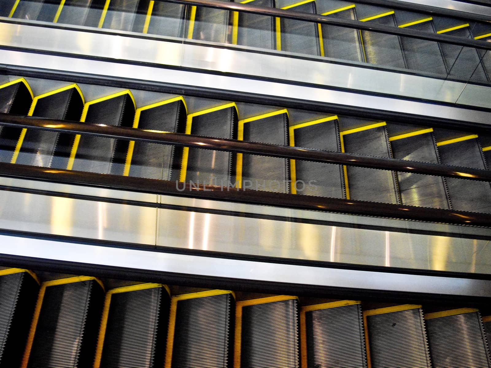 Three moving escalators with no people