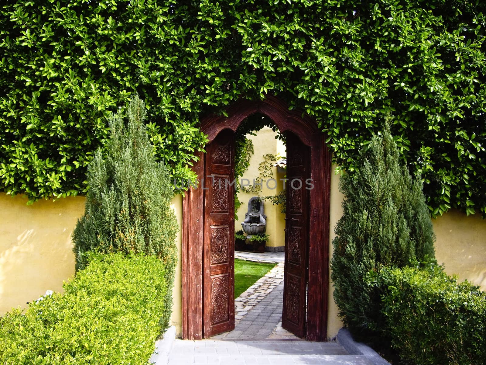 Carved wooden doorway leads to secret garden