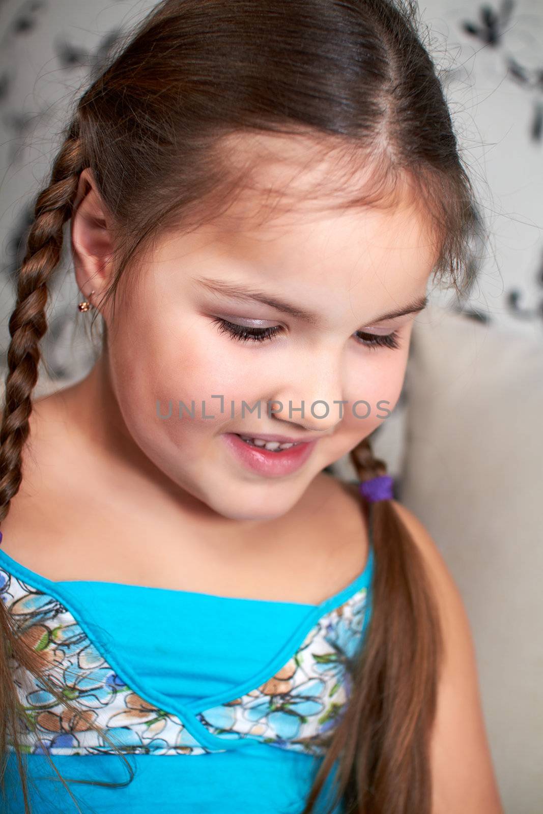 Little girl sitting and thinking.