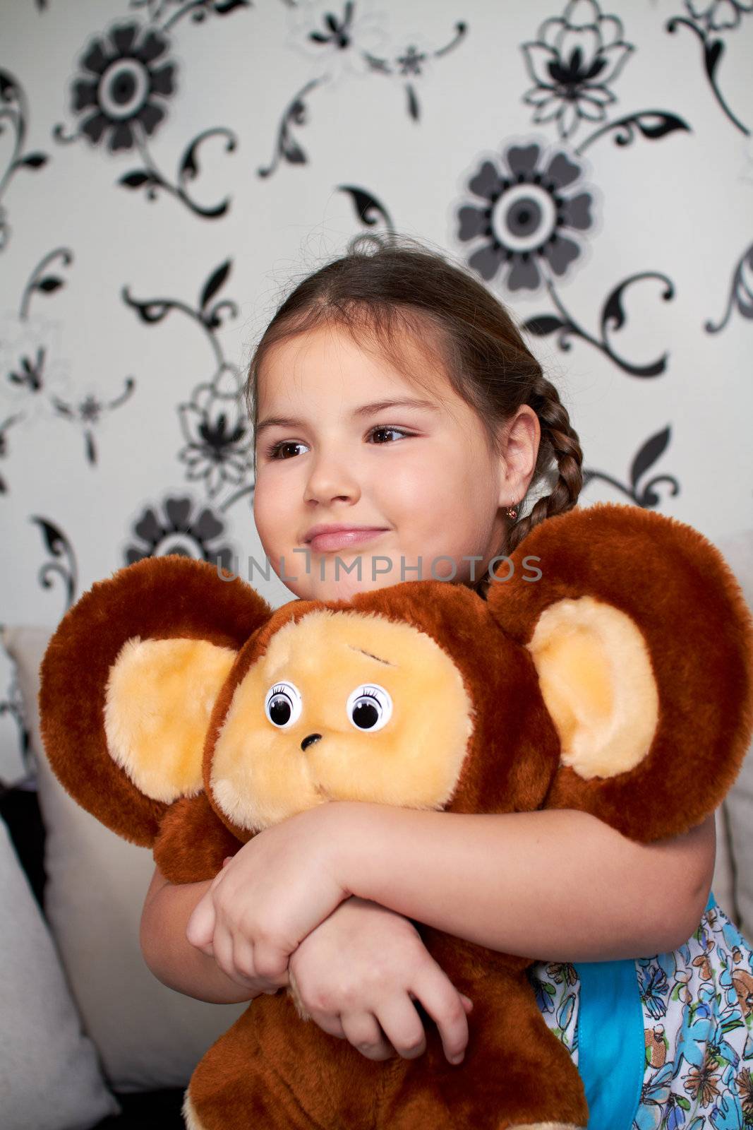 A little girl with a big plush toy.