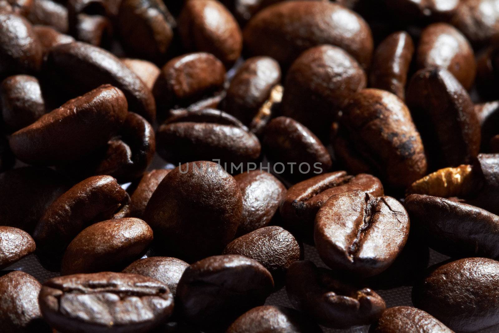 Pile of roasted black coffee.