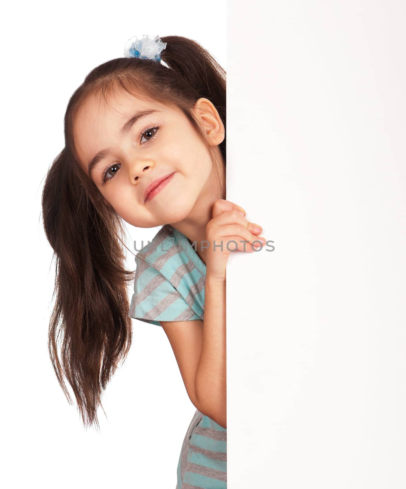 Smiling little girl holding empty white board