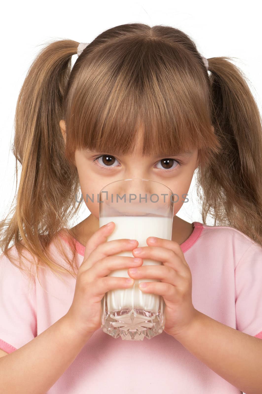 Cute little girl drinking a glass of milk isolated on white background