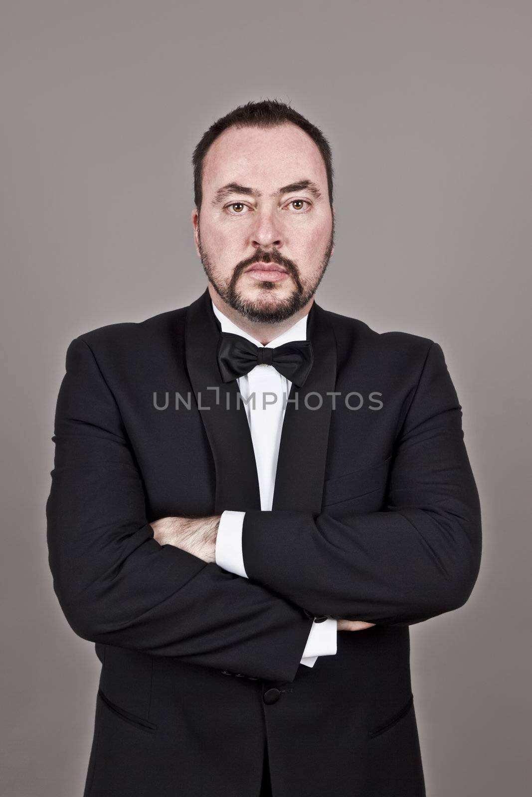 A handsome man with a beard in a black suit