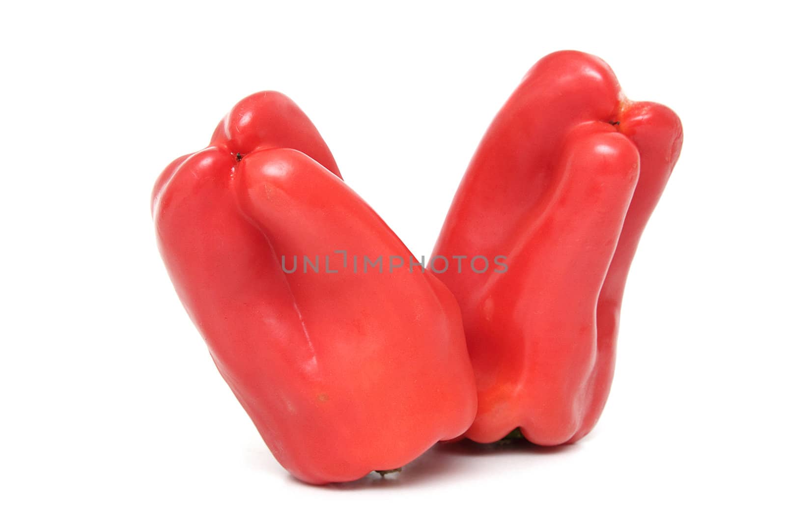 Two red peppers isolated over white background